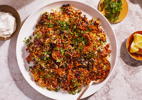 Fragrant biryani on a plate with 3 sides served at Chilli Grill takeaway 
in Glasgow 